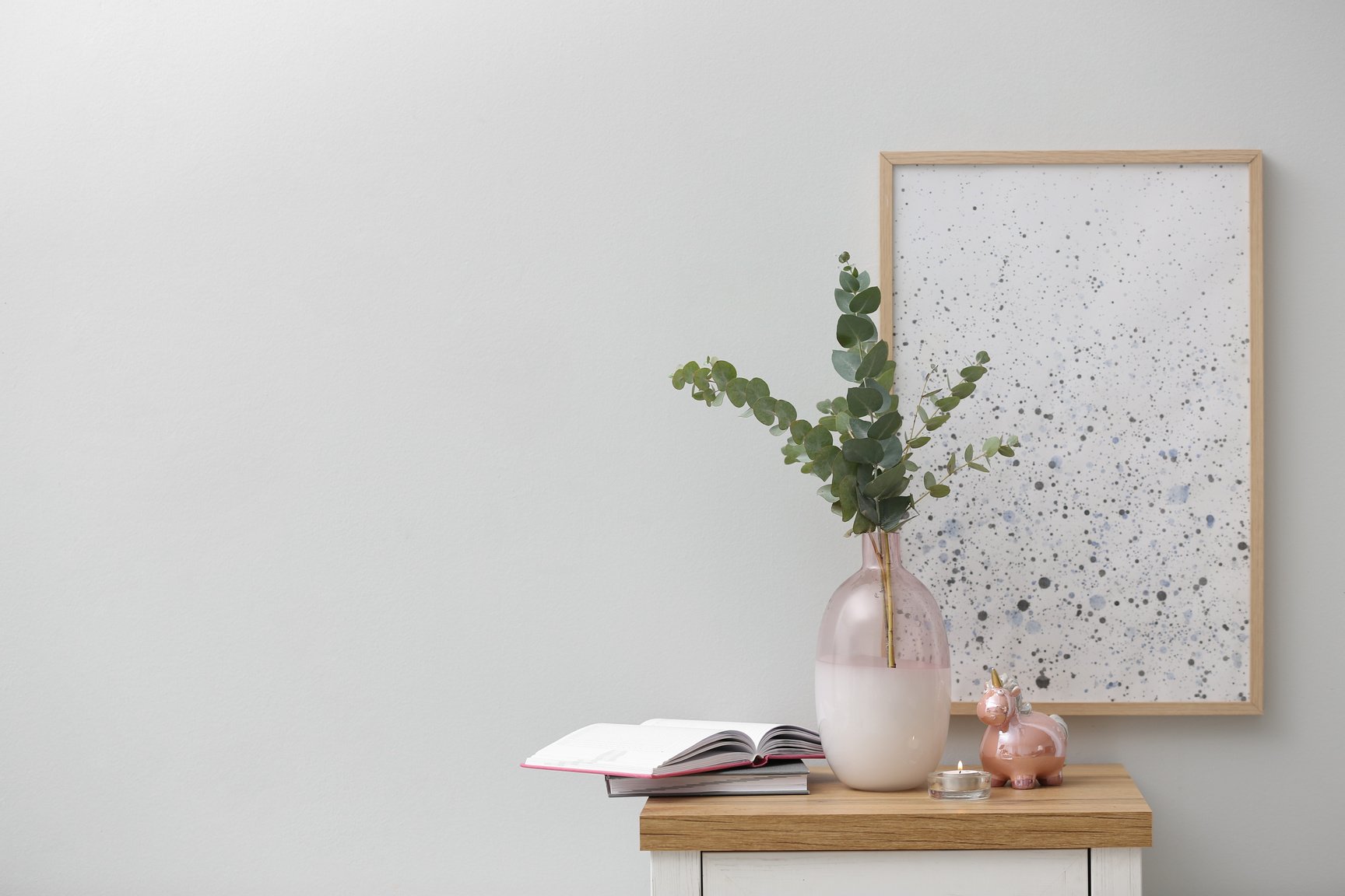 Vase with Fresh Eucalyptus Branches on Cabinet in Room. Interior Design